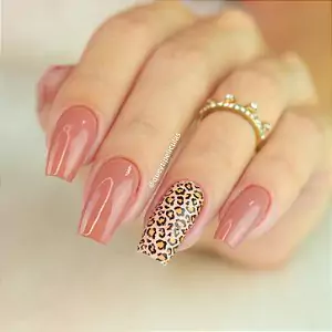 a hand with long nails painted with leopard print